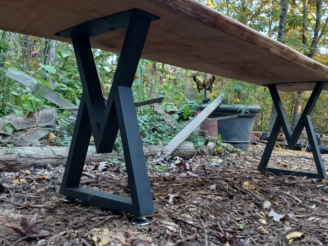 End view showing the bench slab and steel legs