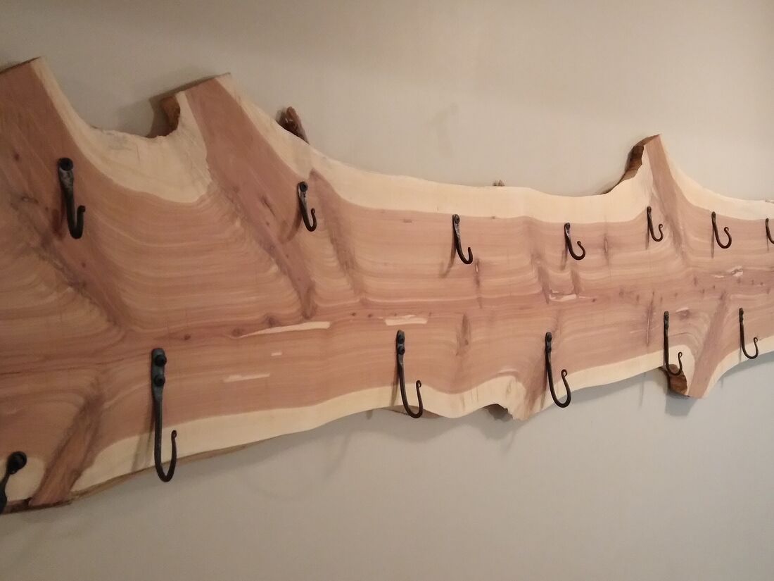 Live edge cedar coat rack with forged iron hooks