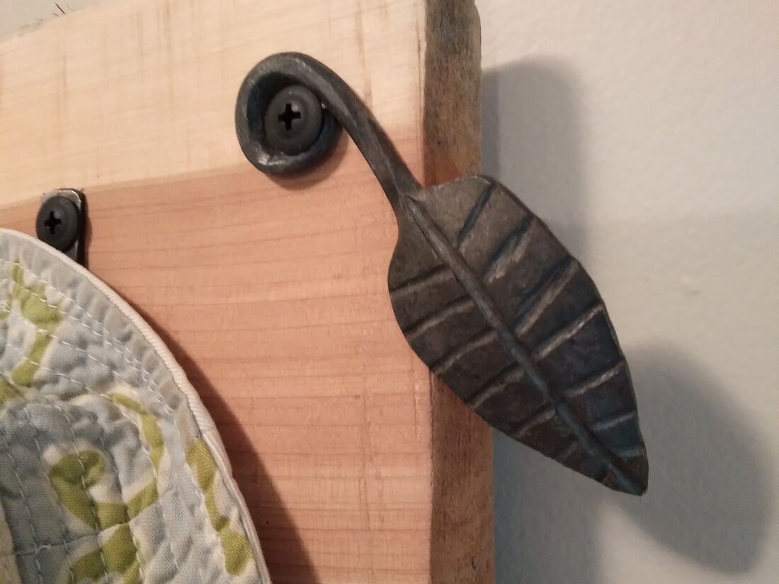 Forged iron leaf hook on cedar